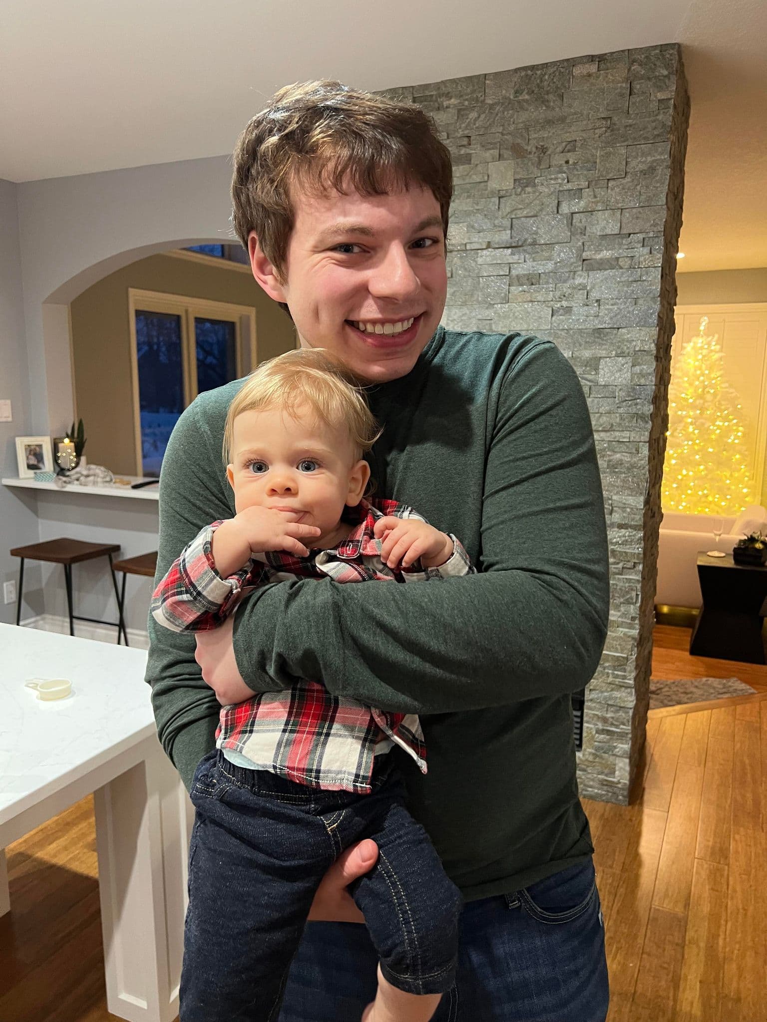 Josh holding Harrison at Chirstmas