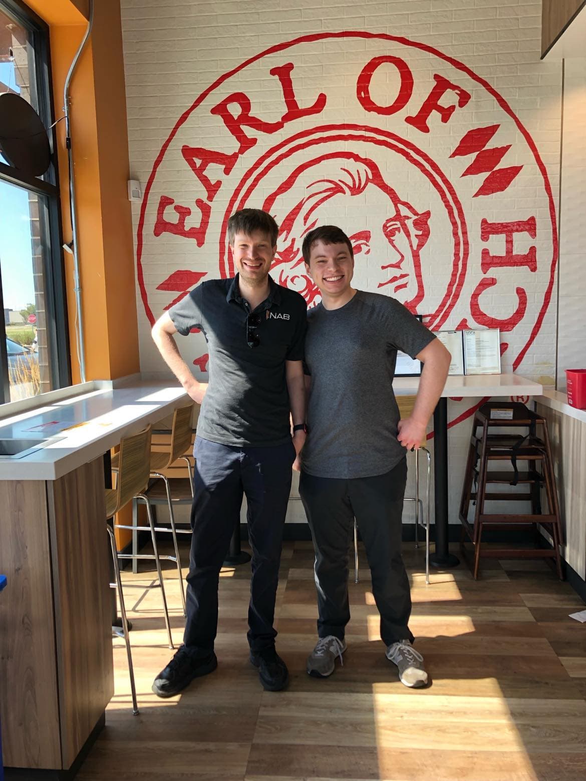 Josh and Peter in front of the Earl of Sandwich sign