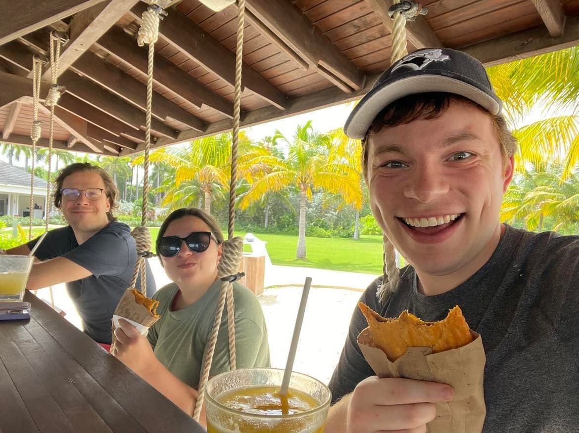 Josh, Cassie and Grant drinking drinks and eating patties