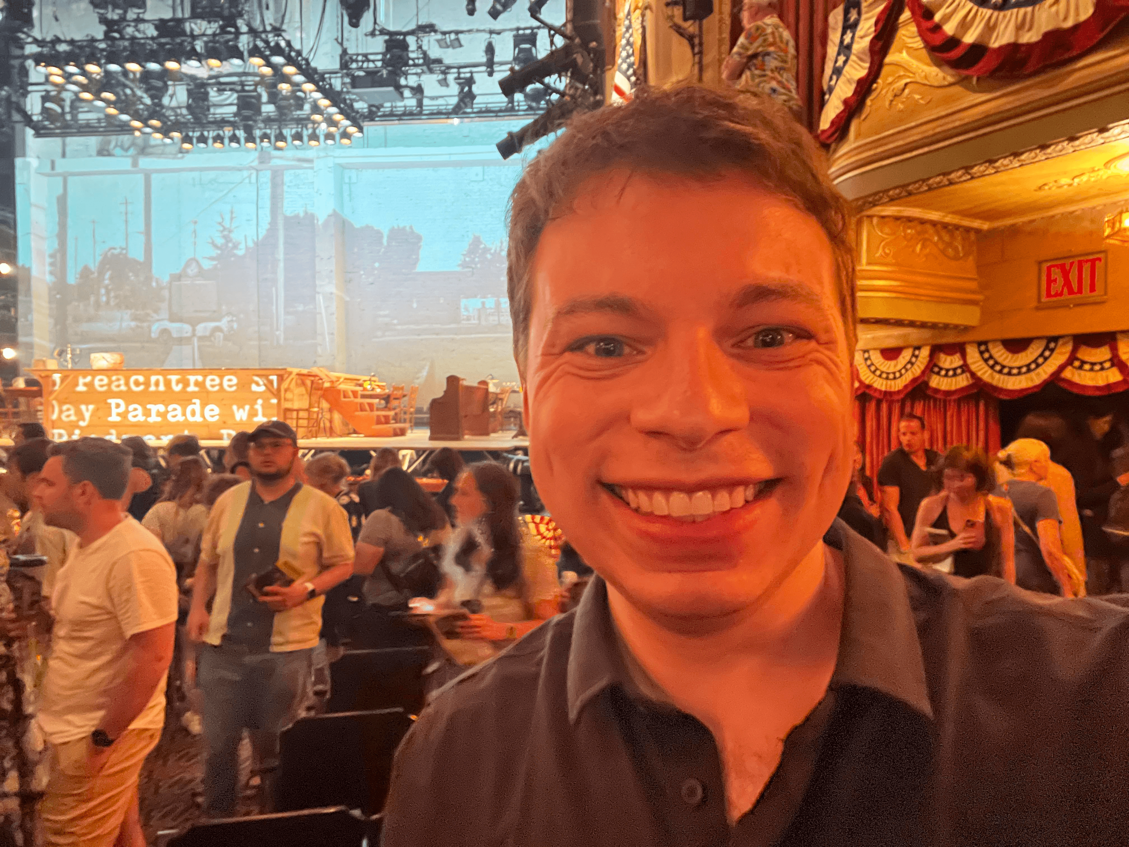 Josh smiling in front of the parade stage.